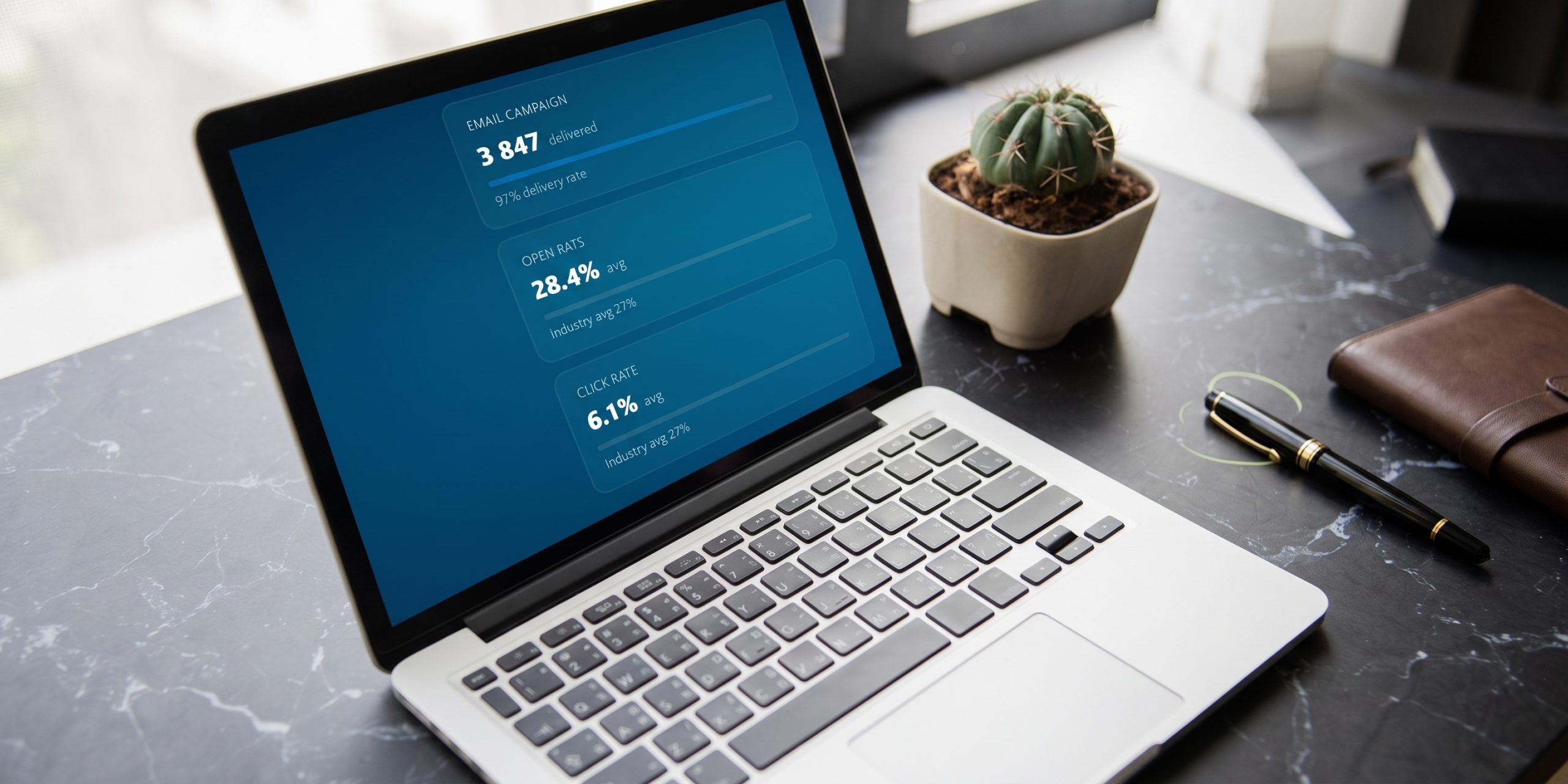 image of a laptop open showing click rates and open rates